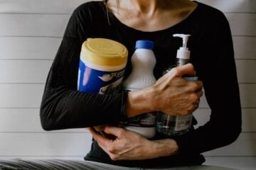 Image of woman holding cleaning products